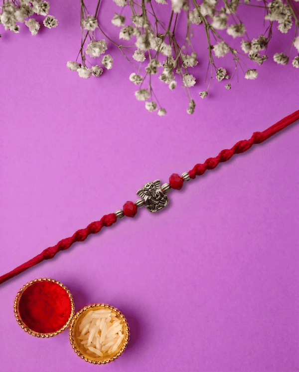 Elegant Silver Ganesha with Sacred Red Thread Bhai Rakhi