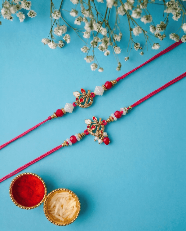 Krishna Bansuri & Mor Pankh Red Designer Couple Rakhi Set
